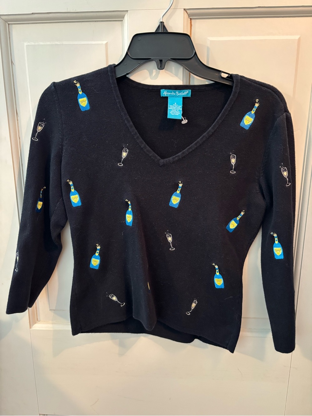 Alexandra Bartlett Black V-Neck Sweater with Blue & Yellow Bottle Embroidery